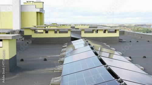 Modern rooftop solar array on a tall building, highlighting sustainable city infrastructure.