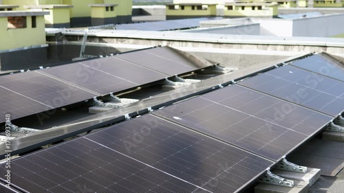 Modern rooftop solar array on a tall building, highlighting sustainable city infrastructure.