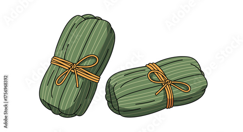 Two traditional asian rice dumplings tied with rustic twine and wrapped in green leaves.