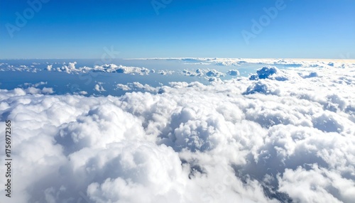 Stunning aerial view of endless fluffy white clouds stretching across a vast blue sky, evoking feelings of freedom and wonder on a clear day.