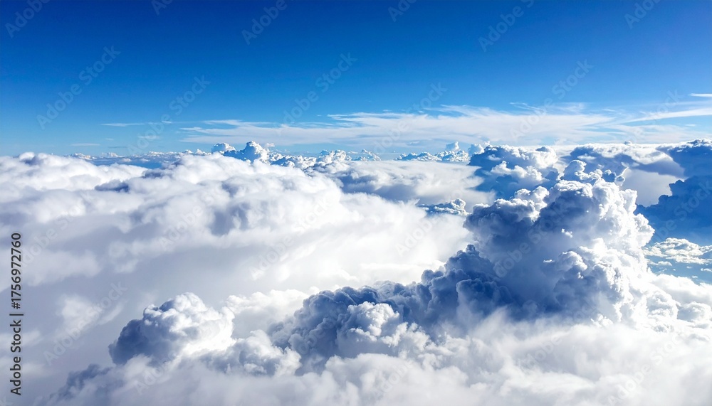Fototapeta premium Majestic white clouds drift serenely across a brilliant blue sky, offering a sense of peace and boundless possibility for your next project