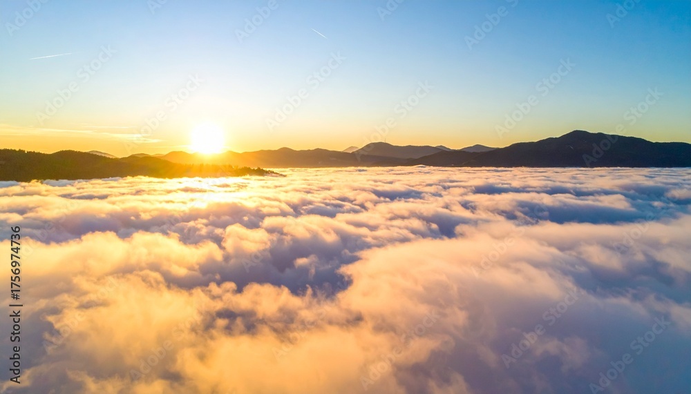 Fototapeta premium Breathtaking sunrise illuminates a sea of clouds above mountain peaks, casting golden light across the serene landscape, inspiring peace and wonder