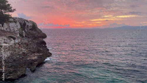Scenic ocean sunset over a rocky coastline in mallorca