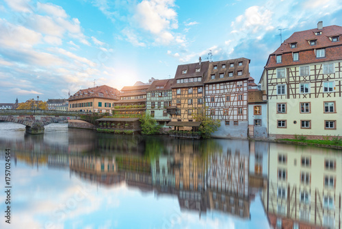 Fototapeta Naklejka Na Ścianę i Meble -  Sunset at Petite France in Strasbourg France Terraces and half-timbered houses, as seen from pont Saint-Martin in la Venise France