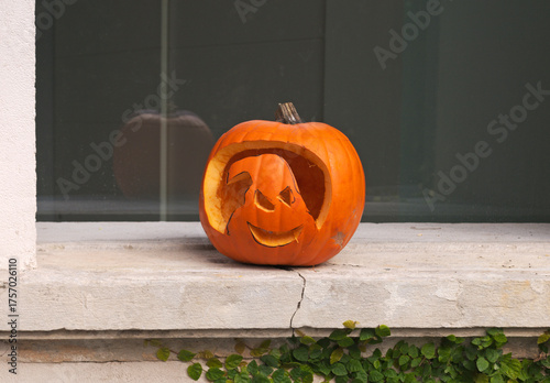 a carved pumpkin on windowsill