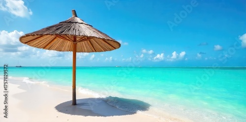 Vibrant turquoise waters lap a pristine Bahamas beach, shaded by a classic straw umbrella Relaxing tropical scene perfect for travel and vacation imagery , ocean, clouds, paradise