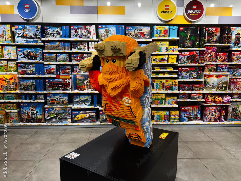Naklejka premium Plastic brick sculpture of Ninjago in a LEGO store display, bright and colorful