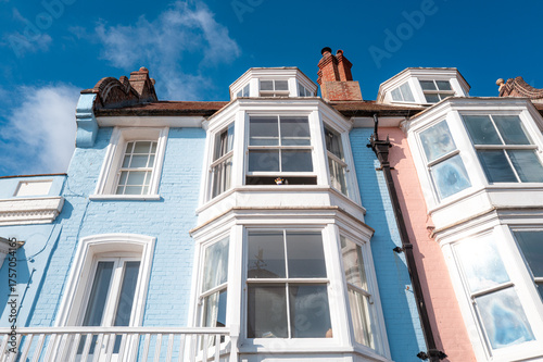 Tall townhouses seen in pastel colours with there large sash windows. The houses over look the popular tourist destination of Aldeburgh, Suffolk, UK.