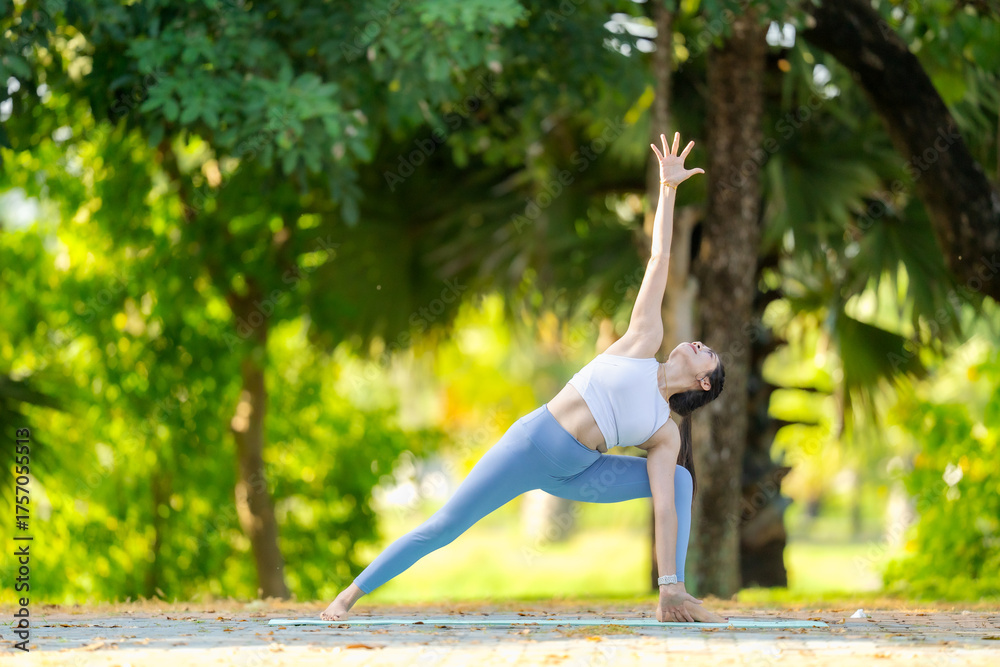 Fototapeta premium Practicing a deep side stretch yoga pose while connecting with breath and nature a calming, meditative outdoor experience.