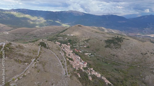 Drone aerial view of Monte Calascio, Abruzzo, featuring the medieval Rocca fortress and spectacular surrounding mountain landscapes