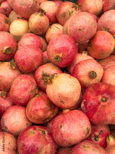 heap of Fresh pomegranates at local farmers market. fruit background
