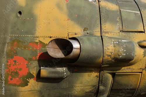 Details of the fuselage of an old aircraft. Old camouflage surface with exfoliated paint and rivets on a military aircraft.
