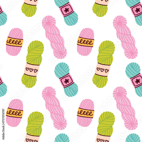 Pink and green skeins of yarn repeating in seamless design for textile, fabric and knitting craft themes.