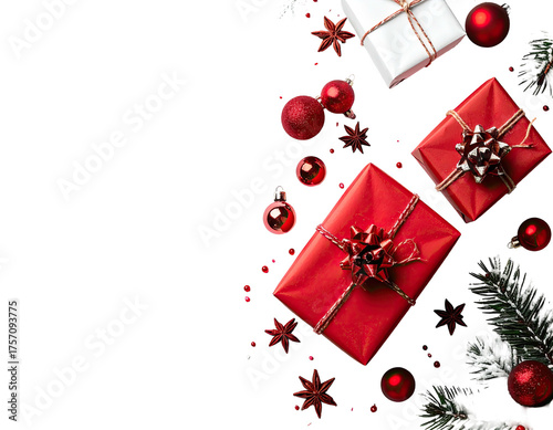 Festive Christmas arrangement of wrapped gifts, ornaments, and greenery against black background
