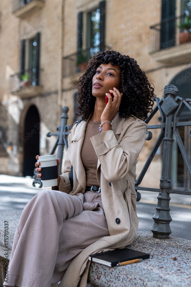 Fototapeta premium Young woman enjoying city lifestyle, talking on phone