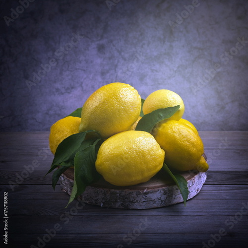 Lemons with green leaves. Still life with citrus fruits.