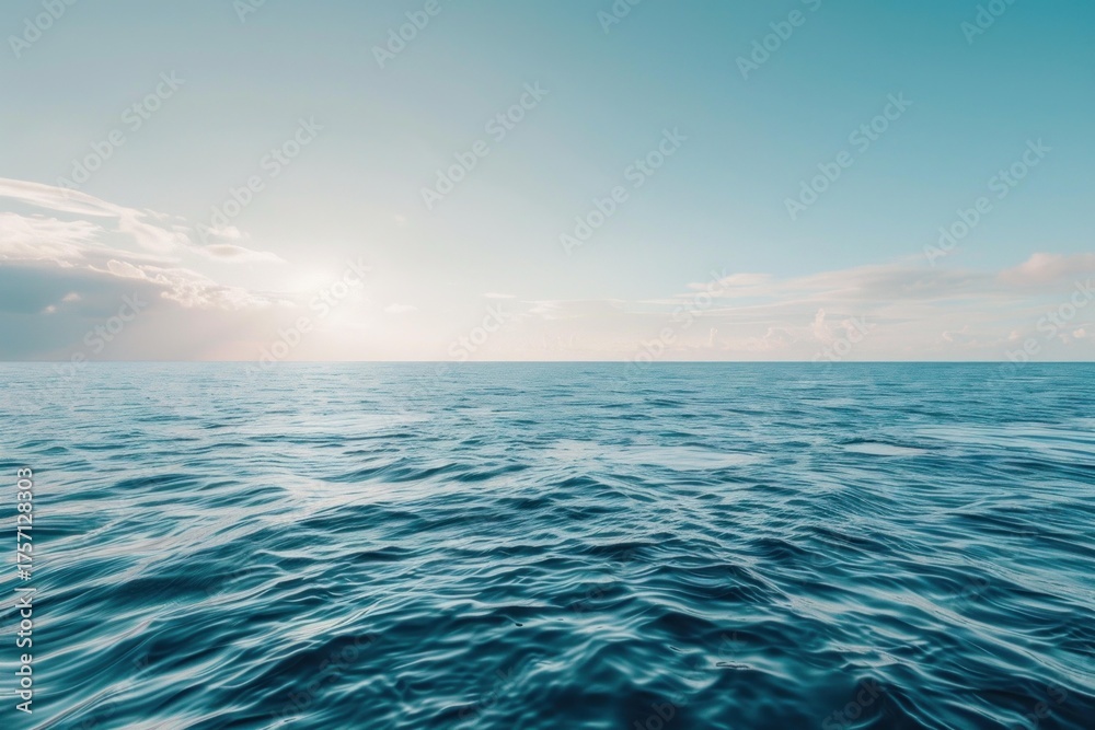 Fototapeta premium Tranquil ocean scene with sun rising over horizon, reflecting on the water surface under a cloudy sky