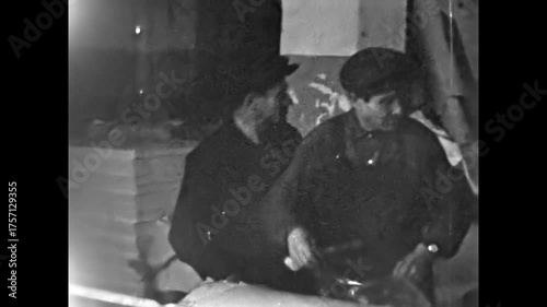 Vintage film, Male factory workers prepare paper roll for production in manufacturing industry. Industrial technology processing. Cardboard material for product. Old archive. Archival retro 1960s