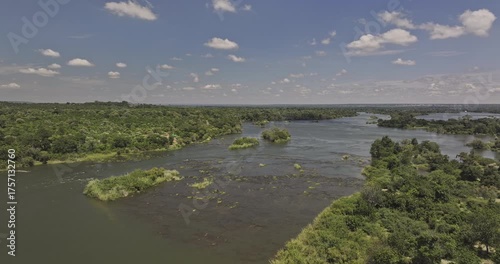 Wallpaper Mural Victoria Falls Zimbabwe Aerial v11 drone flyover capturing Zambezi River flowing through a lush, green landscape dotted with small islands during wet season - Shot with Mavic 3 Pro Cine - Jan 3rd 2024 Torontodigital.ca