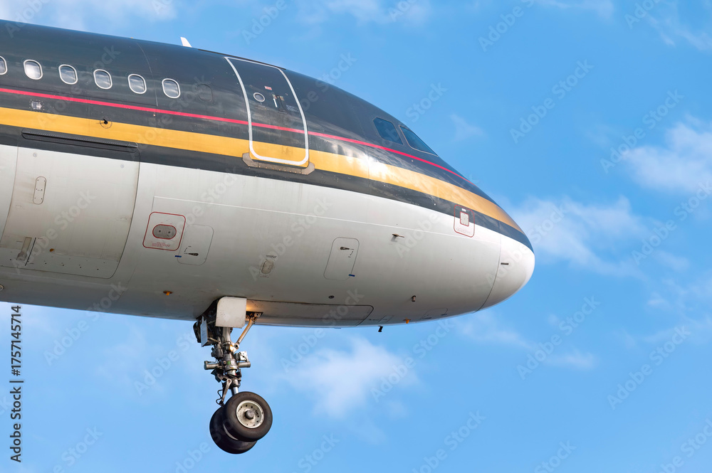 Obraz premium Passenger airplane flying in a blue sky is approaching airport for landing