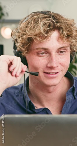 Happy Young Man Communicating on a Video Call, Wearing a Headset for Remote Work or Study