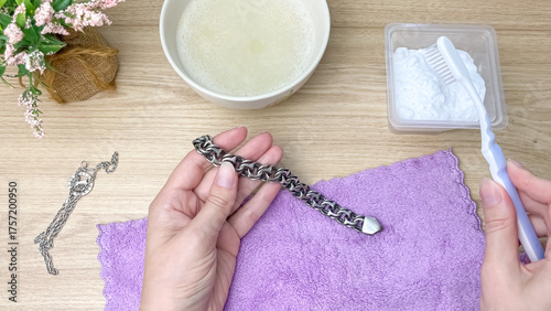 Photos Cleaning silver jewelry with a toothbrush and baking soda, restoring shine and purity to a silver bracelet