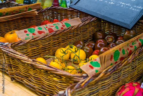 Fresh tomatoes on branch in wicker baskets. High quality photo