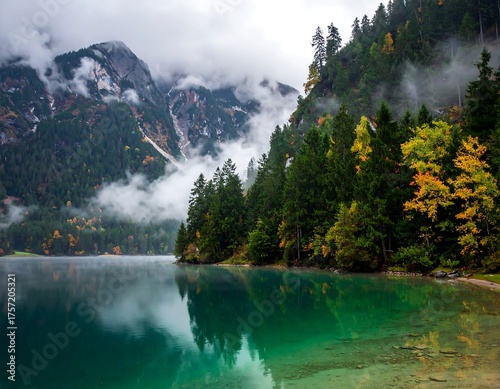 Misty mountain lake reflecting autumnal foliage