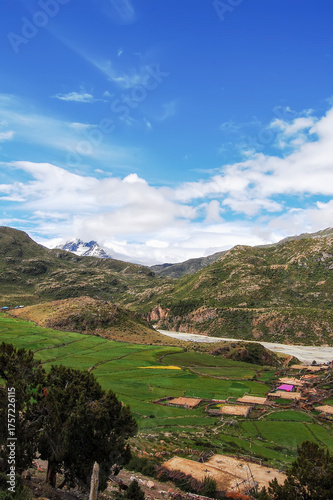 Beautiful mountain landscape with green fields and blue sky