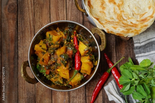 Homemade Aloo methi - potatoes with fenugreek leaves masala served with paratha