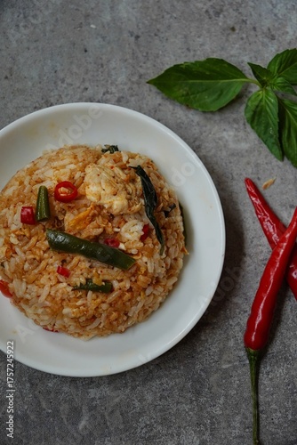 Thai basil fried rice with chicken and veggies served in a bowl, selective focus