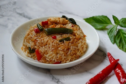 Thai basil fried rice with chicken and veggies served in a bowl, selective focus