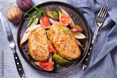 Duck breasts with figs, shallots and sherry gravy. View from above, top studio shot