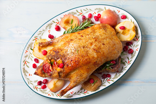 Whole roasted duck with apples. View from above, top studio shot