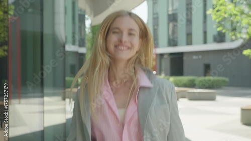 Joyful Young Woman Smiling Directly At Camera In Modern Urban Environment