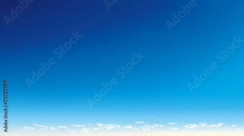 A serene sky filled with gradient of blue color and some clouds. A tranquil and vast landscape