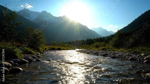 Scenic river flowing through mountains with bright sunlight and clear sky