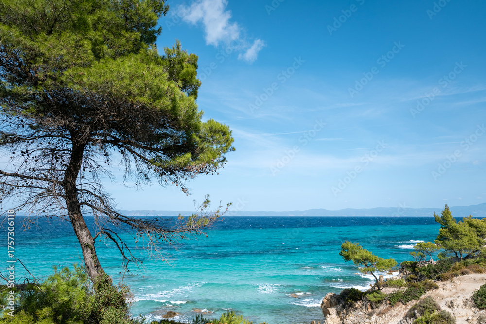 Fototapeta premium Turquoise beach with rocks . Portokali beach, Sithonia, Halkidiki, Greece . Sea background 