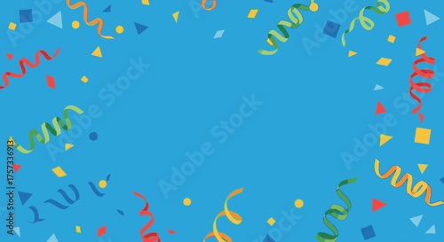 Colorful confetti and streamers are scattered on a blue surface, creating a festive and celebratory.