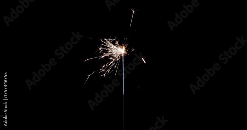 Lightening sparkler on the black background. Sparkler concept. Bengal lights are burning on a black background. Holiday party concept. New year party sparkler. Slow motion.