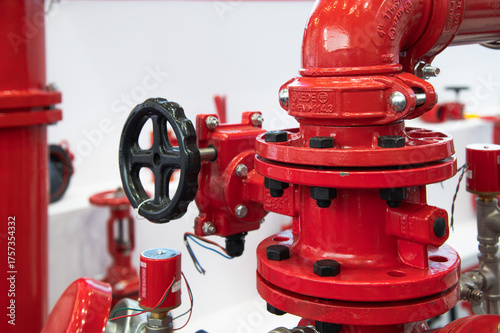 The picture shows a red fire hose with a black handle