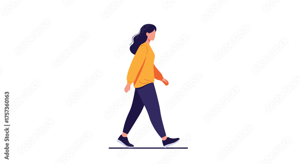 Fototapeta premium A woman wearing a yellow jacket walks with her dark pants and black sneakers.