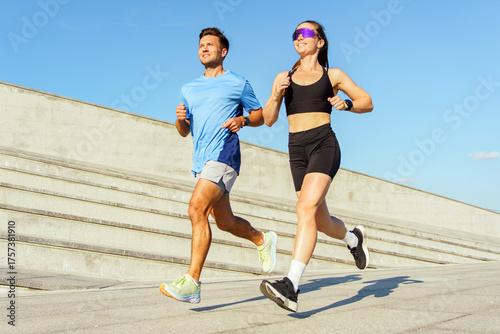 Εκτύπωση καμβά Jogging couple enjoys outdoor exercise on a sunny day at a modern city park with