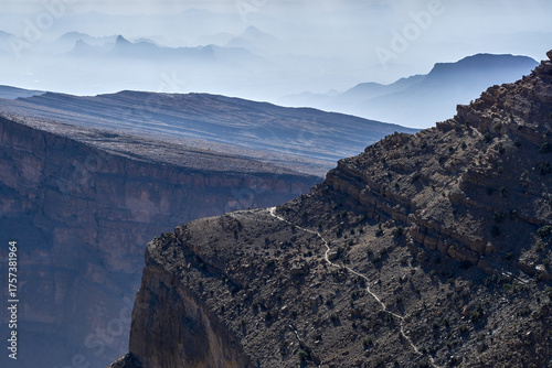 Tableau sur toile Layered mountains fade into a hazy blue distance