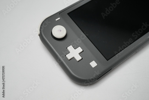 Nintendo Switch Lite Handheld Console in Grey on White Surface