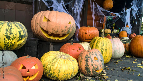 Colorful Carved Pumpkins with Spider Webs Creating a Spooky Halloween Atmosphere