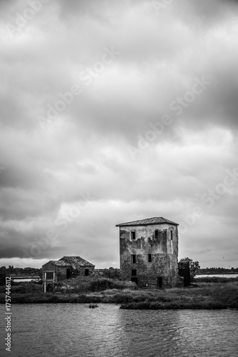 Abandoned building in front of a lagoon. Creepy construction exterior, no people.