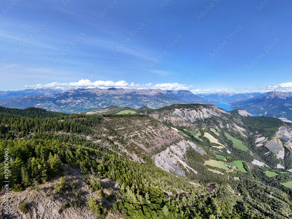 Naklejka premium Panoramic view of Lac Serre-Poncon lake surrounded by mountains and valleys, Hautes-Alpes, France, Europe.