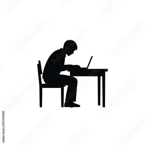 Person working on laptop at desk silhouette