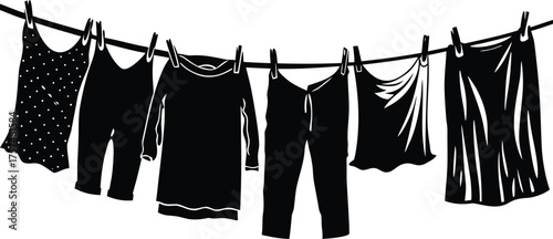 Black clothes drying on a clothesline outdoors